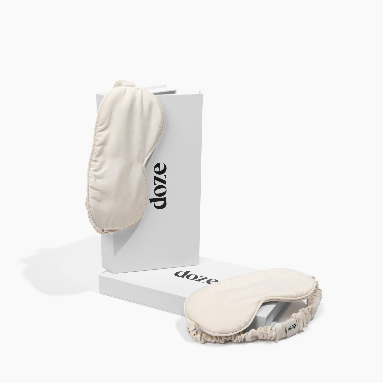 Two beige sleep masks on white boxes labeled 'doze.'